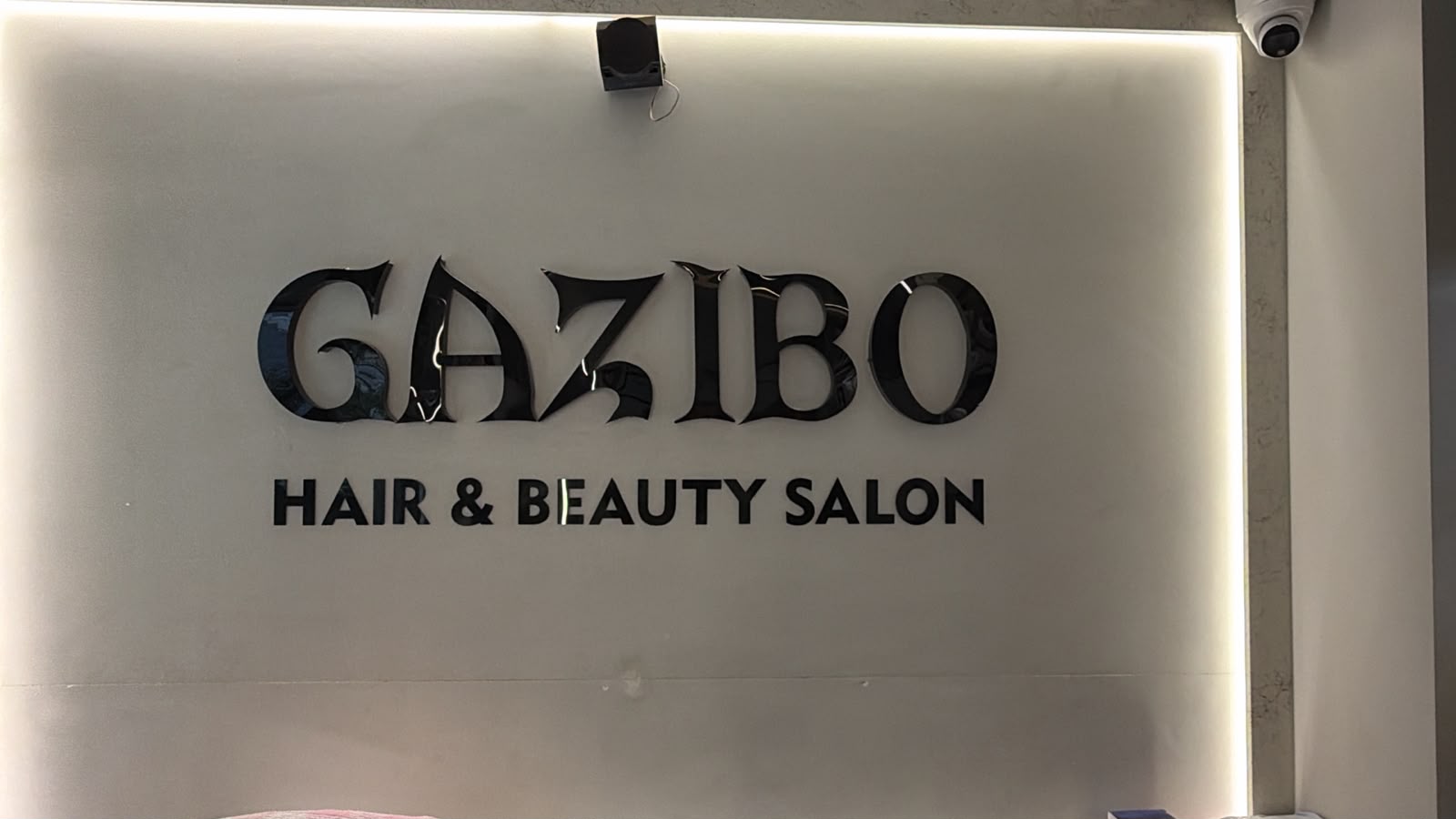 Gazibo salon reception desk with brand signage